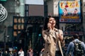 Asian businesswoman on cellphone walking