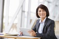 Asian businesswoman with digital tablet, smiling to camera