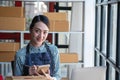 An Asian businesswoman enjoys his online SME business selling products, profiting from opening an online store, and taking orders Royalty Free Stock Photo