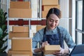 An Asian businesswoman enjoys his online SME business selling products, profiting from opening an online store, and taking orders Royalty Free Stock Photo