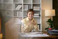 An Asian businesswoman or female boss sits at her desk in the office Royalty Free Stock Photo