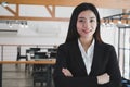 Asian businesswoman with folded hands smiling at camera. confide Royalty Free Stock Photo