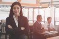 Asian businesswoman with folded hands smiling at camera. confide Royalty Free Stock Photo