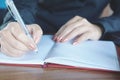 Asian businesswoman hand writing on notebook working at office desk Royalty Free Stock Photo