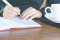 Asian businesswoman hand writing on notebook working at office desk Royalty Free Stock Photo
