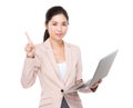 Asian Businesswoman hold with laptop and finger point up Royalty Free Stock Photo