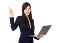 Asian businesswoman hold with notebook computer and finger point Royalty Free Stock Photo