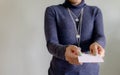 Asian businesswoman holding a blank business card and smiling at the camera. Chinese woman professional holding a blank white Royalty Free Stock Photo