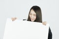 Asian businesswoman holding blank white card board sign. Royalty Free Stock Photo