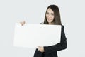 Asian businesswoman holding blank white card board sign. Royalty Free Stock Photo