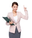 Asian businesswoman holding with clipboard and finger point up Royalty Free Stock Photo