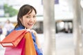 Asian businesswoman holding colorful paper shopping bags on hand , business consumer concept Royalty Free Stock Photo