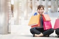 Asian businesswoman holding colorful paper shopping bags on hand. Royalty Free Stock Photo