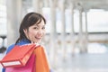 Asian businesswoman holding colorful paper shopping bags on hand Royalty Free Stock Photo