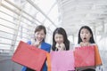 Asian businesswoman holding colorful paper shopping bags on hand Royalty Free Stock Photo