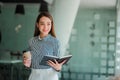 Asian businesswoman holding a cup of coffee working on investment projects and financial accounting planning strategies. Businessm Royalty Free Stock Photo