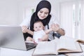 Asian Businesswoman Playing with Baby Boy