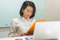 Asian businesswoman reading report folder in the office Royalty Free Stock Photo