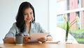 Asian businesswoman reviewing a business proposal report, analysing financial document