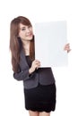 Asian businesswoman show a vertical blank sign on her left Royalty Free Stock Photo