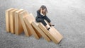 Asian businesswoman sitting on topple wooden block