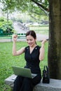 Asian businesswoman smiling and raising up two hands to celebrate for business successful Royalty Free Stock Photo
