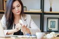 Asian businesswoman squeeze paper in hand sitting at office desk