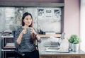 Asian businesswoman take a coffee break after working with smiling face,Happy office life concept,working woman at modern home