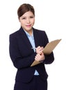 Asian businesswoman take note on clipboard Royalty Free Stock Photo
