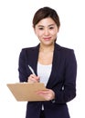 Asian businesswoman take note on clipboard Royalty Free Stock Photo