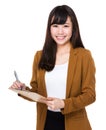 Asian Businesswoman take note on clipboard Royalty Free Stock Photo