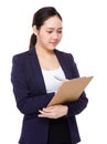 Asian businesswoman take note on clipboard Royalty Free Stock Photo