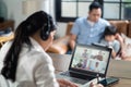 Asian businesswoman talk to colleagues about plan on video conference. Group of business people using computer for online virtual Royalty Free Stock Photo