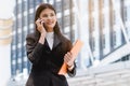 Asian businesswoman talking mobile phone with client and confirm to attend meeting Royalty Free Stock Photo