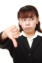 Asian businesswoman with thumbs down gesture