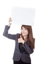 Asian businesswoman thumbs-up hold a blank sign over head Royalty Free Stock Photo