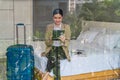 Businesswoman traveller sitting on bed using computer tablet in hotel room Royalty Free Stock Photo