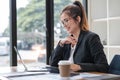 Asian businesswoman use laptop computer in office The Internal Revenue Service audit document balance calculation report Royalty Free Stock Photo