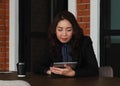 Asian businesswoman using digital tablet PC in office, typing and looking at screen Royalty Free Stock Photo