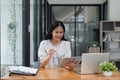 Asian Businesswoman Using laptop computer and tablet working at office with document on desk Royalty Free Stock Photo