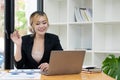 Asian businesswoman using laptop at independent female company desk reading financial graph chart Planning, analyzing, calculating Royalty Free Stock Photo