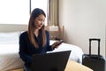 Asian businesswoman using laptop working in hotel room Royalty Free Stock Photo