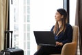 Asian businesswoman using laptop working in hotel room Royalty Free Stock Photo