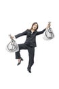 Asian businesswoman walking while holding dollar money bags Royalty Free Stock Photo