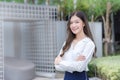 Asian businesswoman wearing a white shirt and standing with her arms crossed smile while working outdoors the office Royalty Free Stock Photo