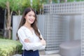 Asian businesswoman wearing a white shirt and standing with her arms crossed smile while working outdoors the office Royalty Free Stock Photo