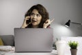 Asian businesswoman work at home with laptop and talking on smartphone and smiling. Female working on computer and using cell mobi