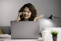 Asian businesswoman work at home with laptop and talking on smartphone and smiling. Female working on computer and using cell mobi