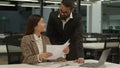 Asian businesswoman worker Korean female manager woman sorting holding papers document paperwork Arabian businessman Royalty Free Stock Photo