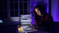 Asian businesswoman working hard late hours with a lot of document at home. Busy and exhausted of work overtime Royalty Free Stock Photo